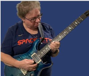 A person playing a guitarAI-generated content may be incorrect.